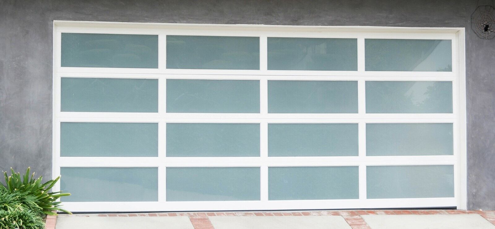 A white garage door with a lot of squares on it.