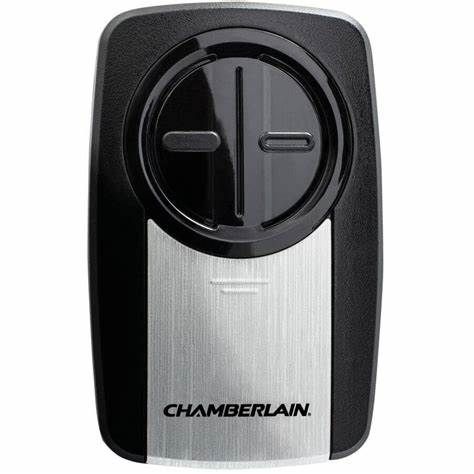 A chamberlain garage door opener remote control is sitting on a white surface.