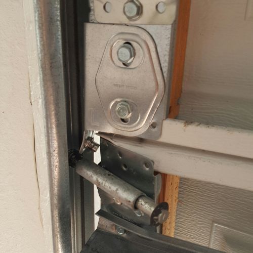 A close up of a metal bracket on a garage door.