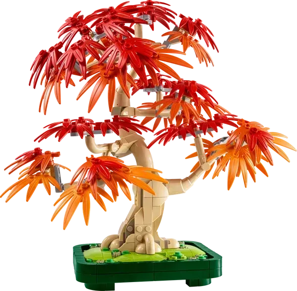 LEGO bonsai tree model with red and orange leaves in a green pot.