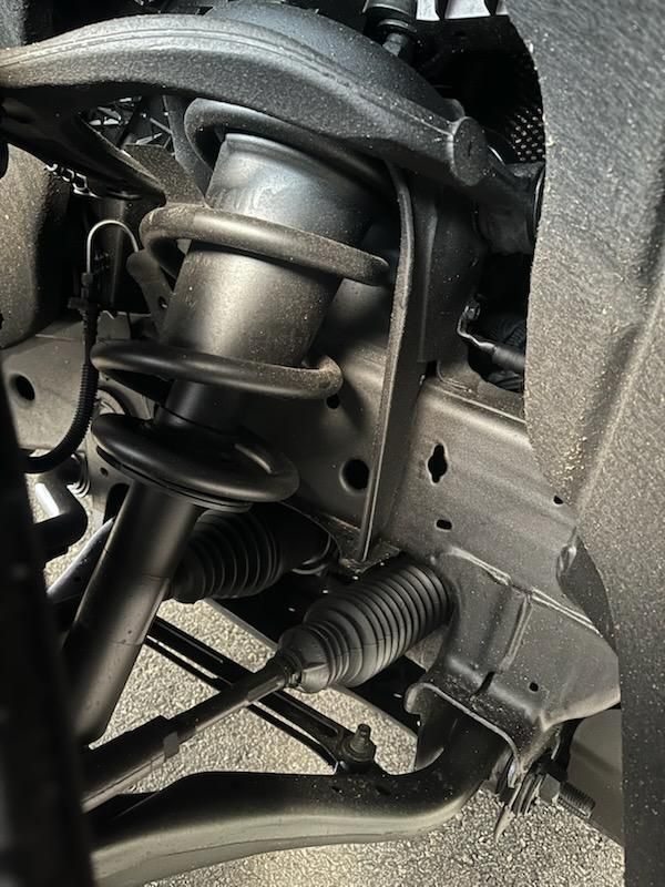 A close up of a suspension system on a car.