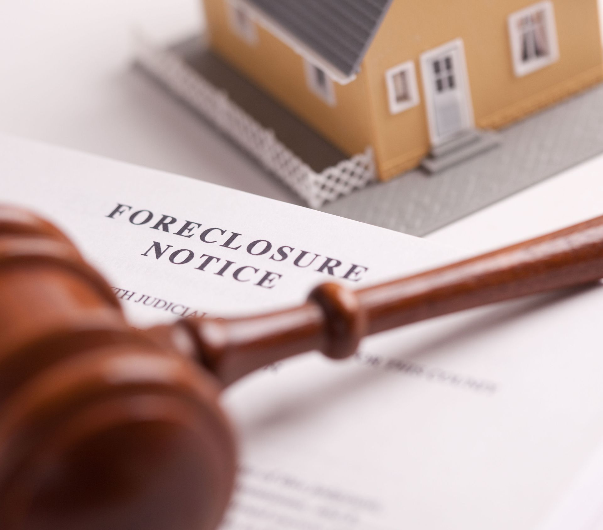 Learn More About Real Estate Wooden gavel on a foreclosure notice