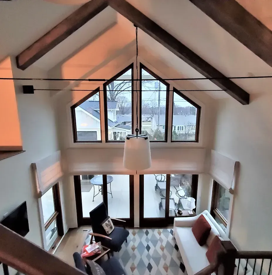 Modern living room with vaulted ceilings, large windows, and mountain view