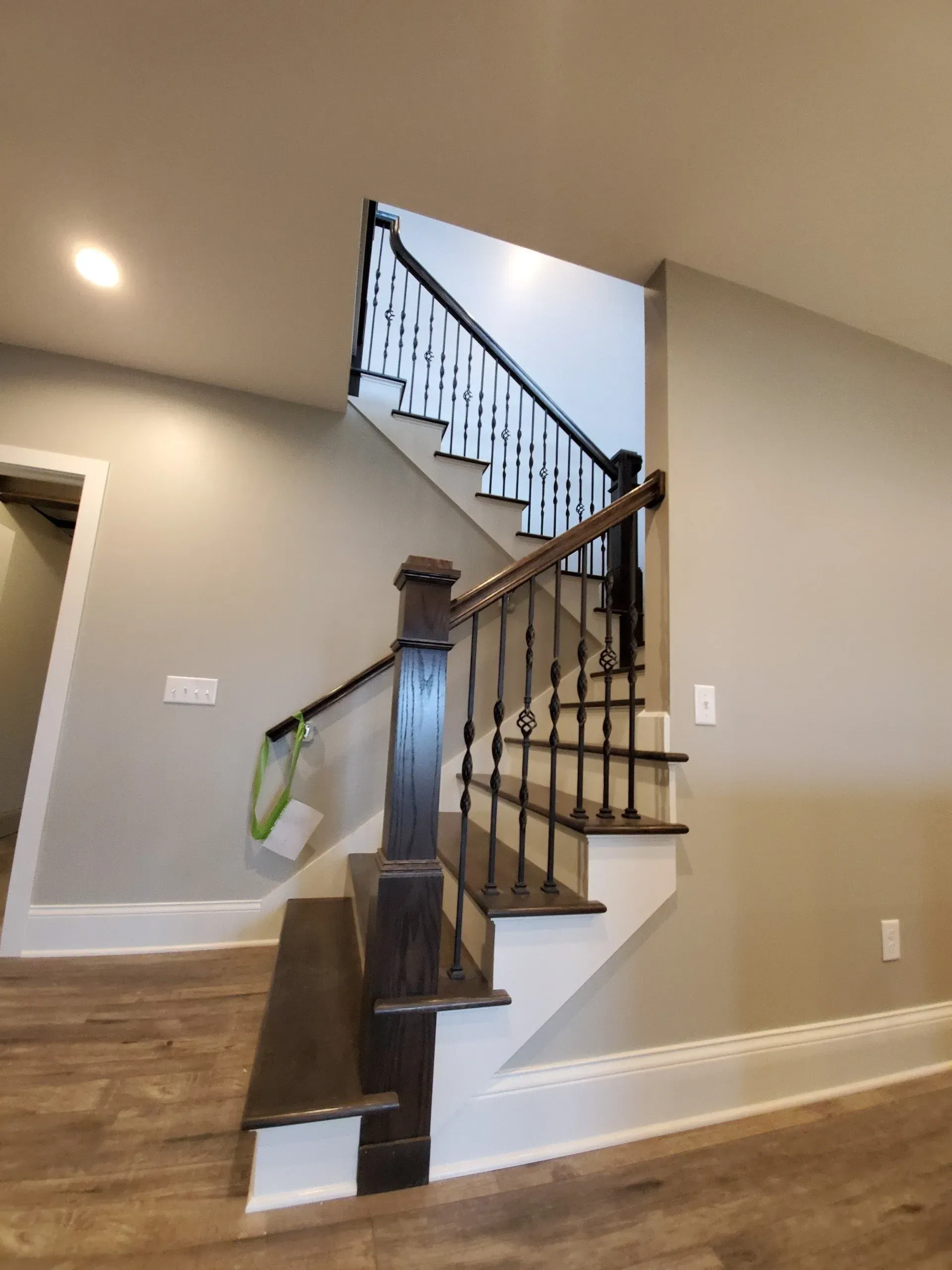 Staircase with dark wood railings and beige walls in a home interior