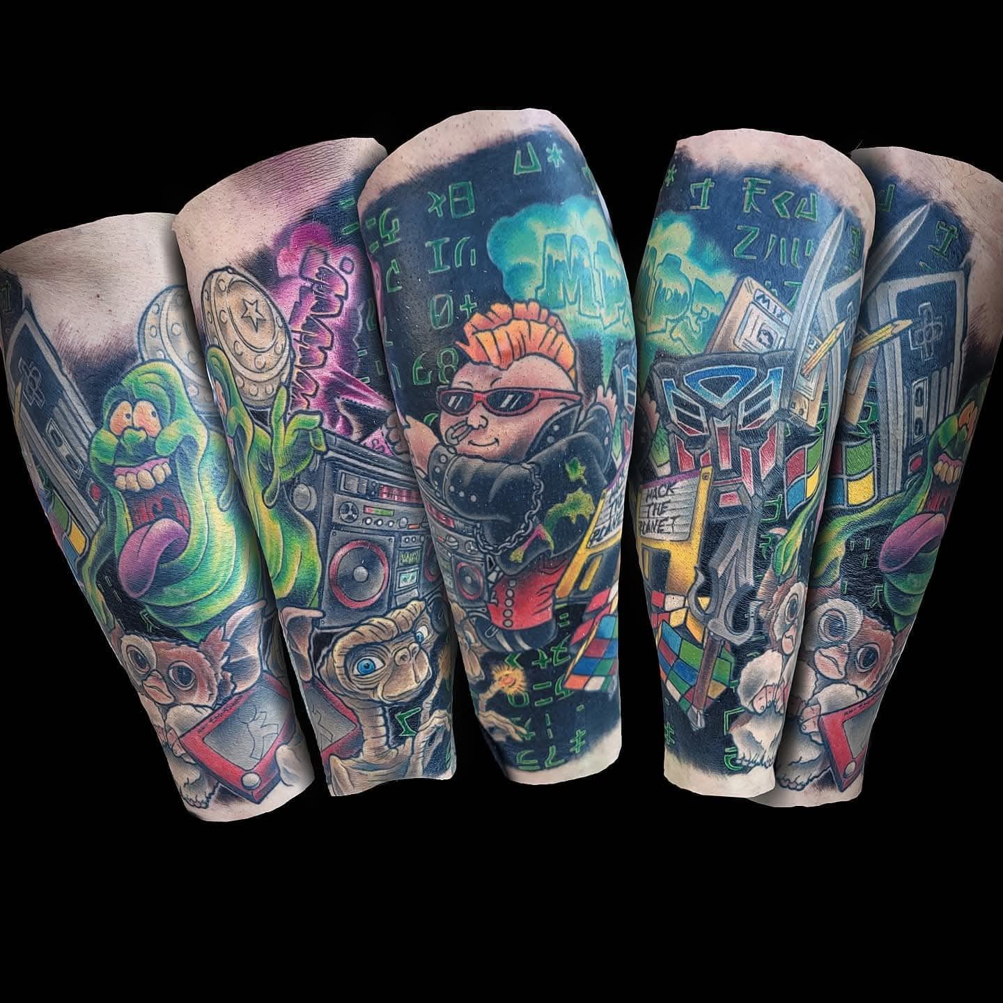 Tattoos on five arms featuring pop culture characters, vibrant colors, including Ghostbusters, ET, and a boombox.