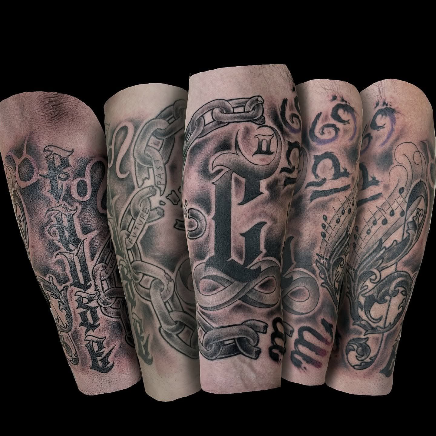 Five arm tattoos of zodiac symbols, chains, and letters 