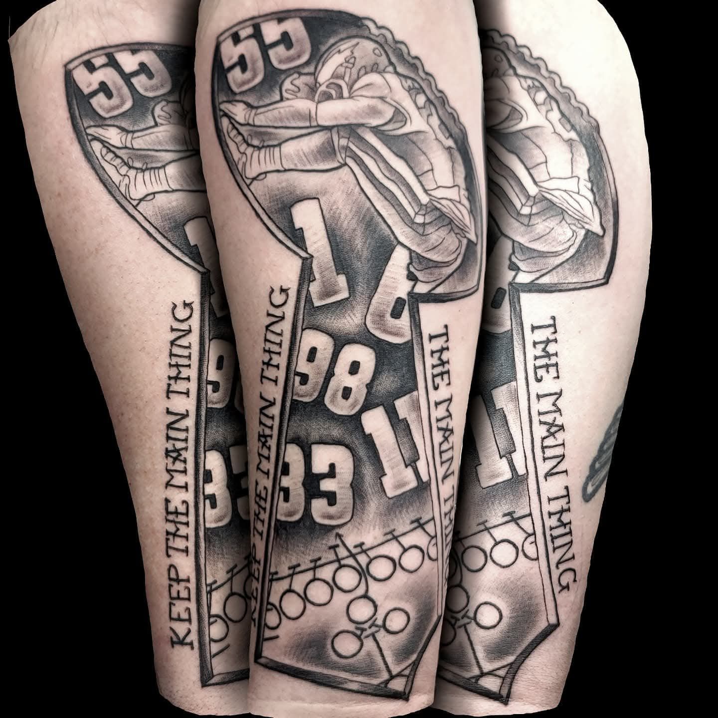 Tattoo of a football trophy with a football player, jersey numbers, and text 