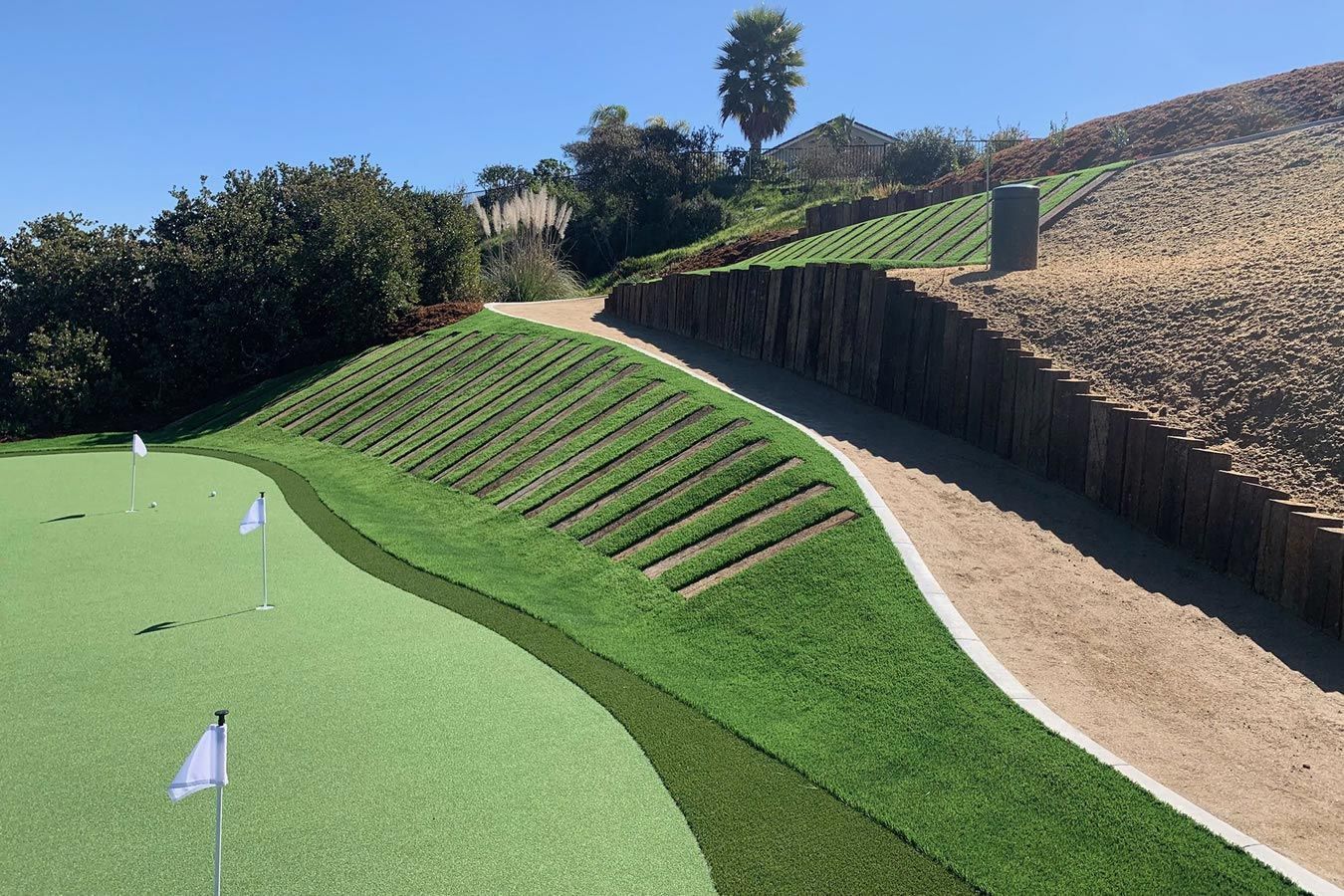 A golf course with a white flag on the green