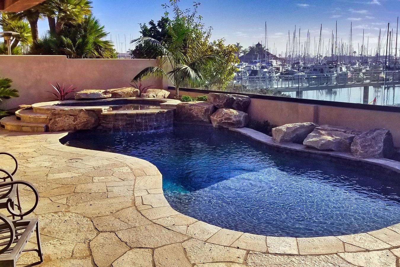 A large swimming pool with a view of a harbor