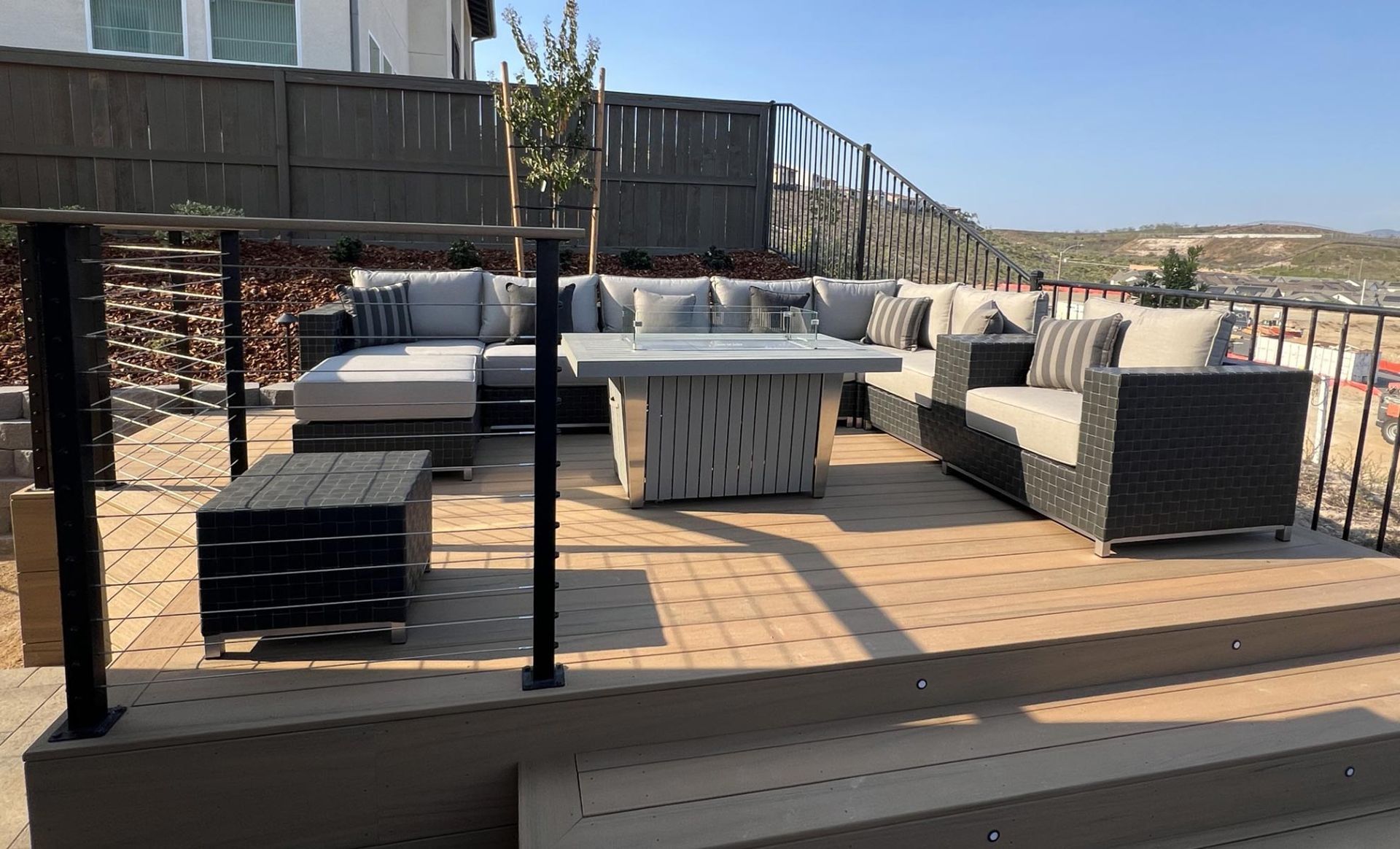 A patio with a lot of furniture and a table