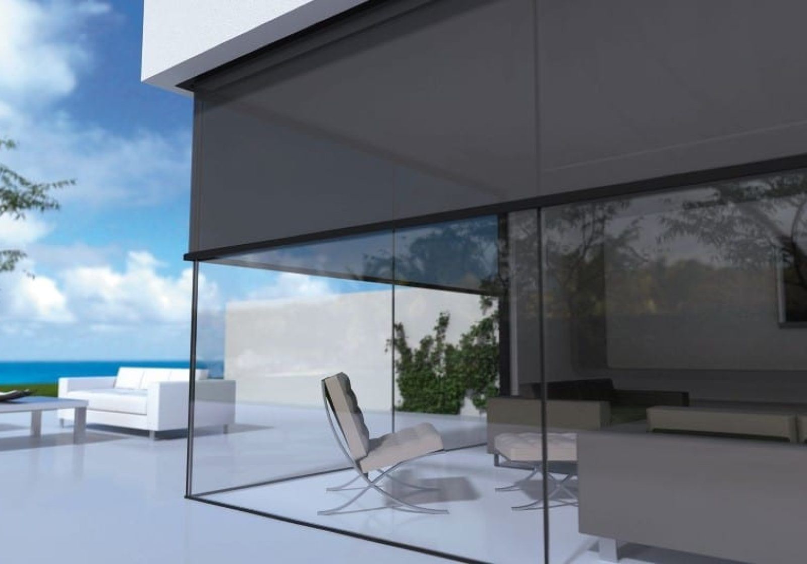 Modern glass-walled patio with white furniture overlooking the ocean