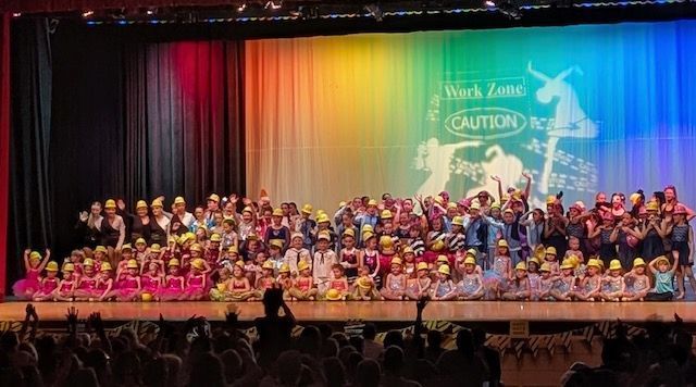 A large group of people are standing on a stage.