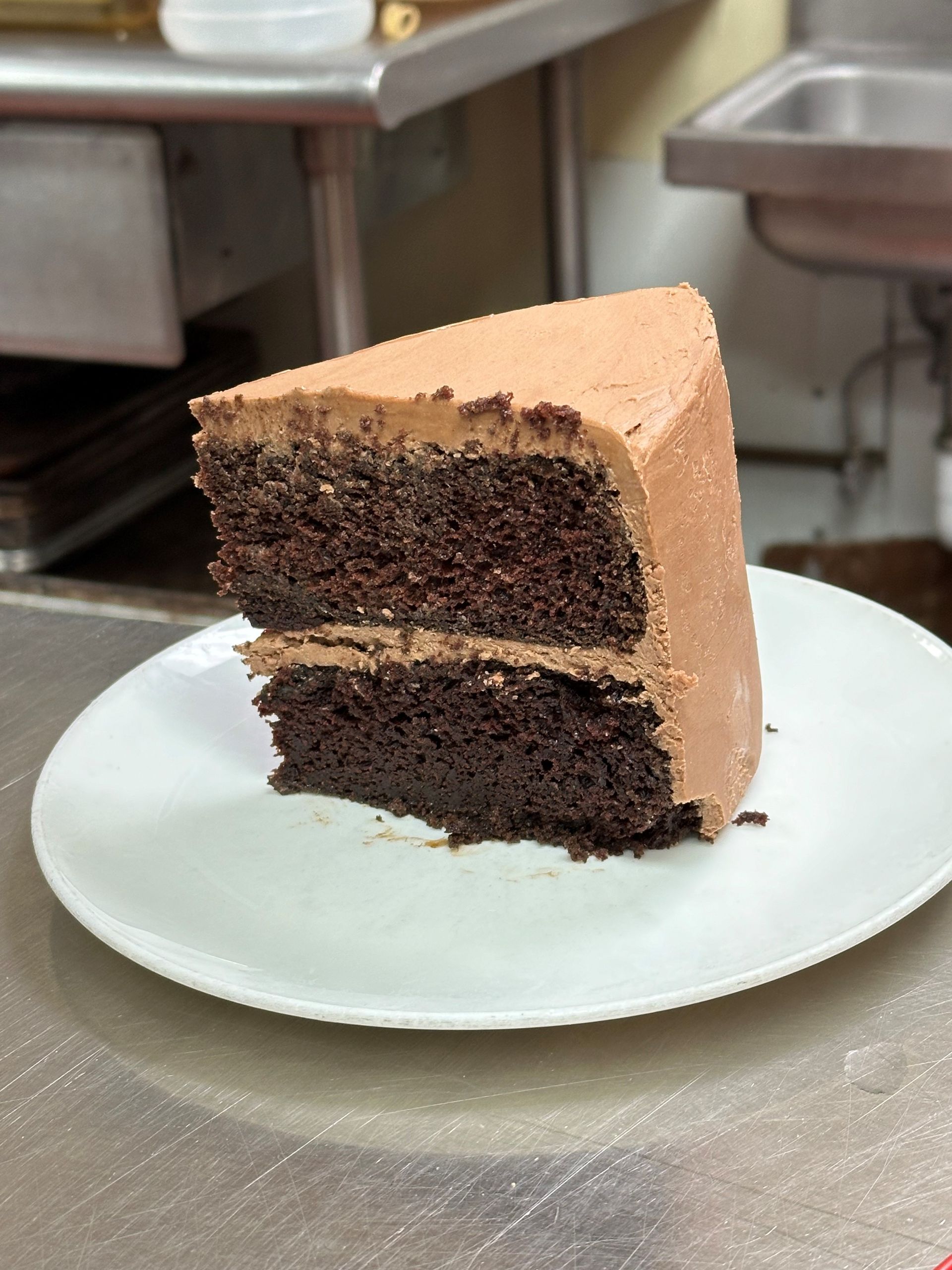 a slice of chocolate cake on a white plate