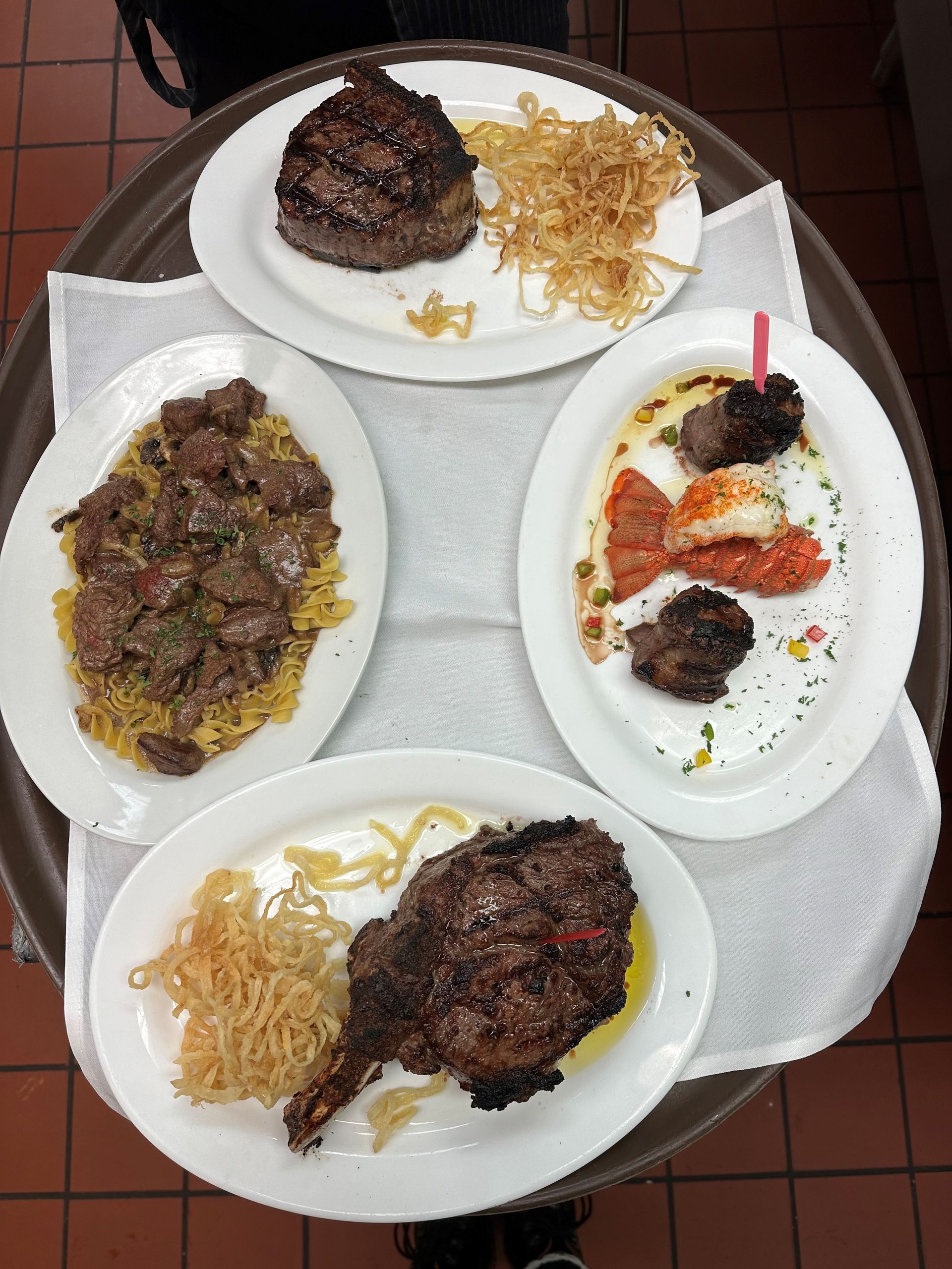 A tray with four plates of food on it
