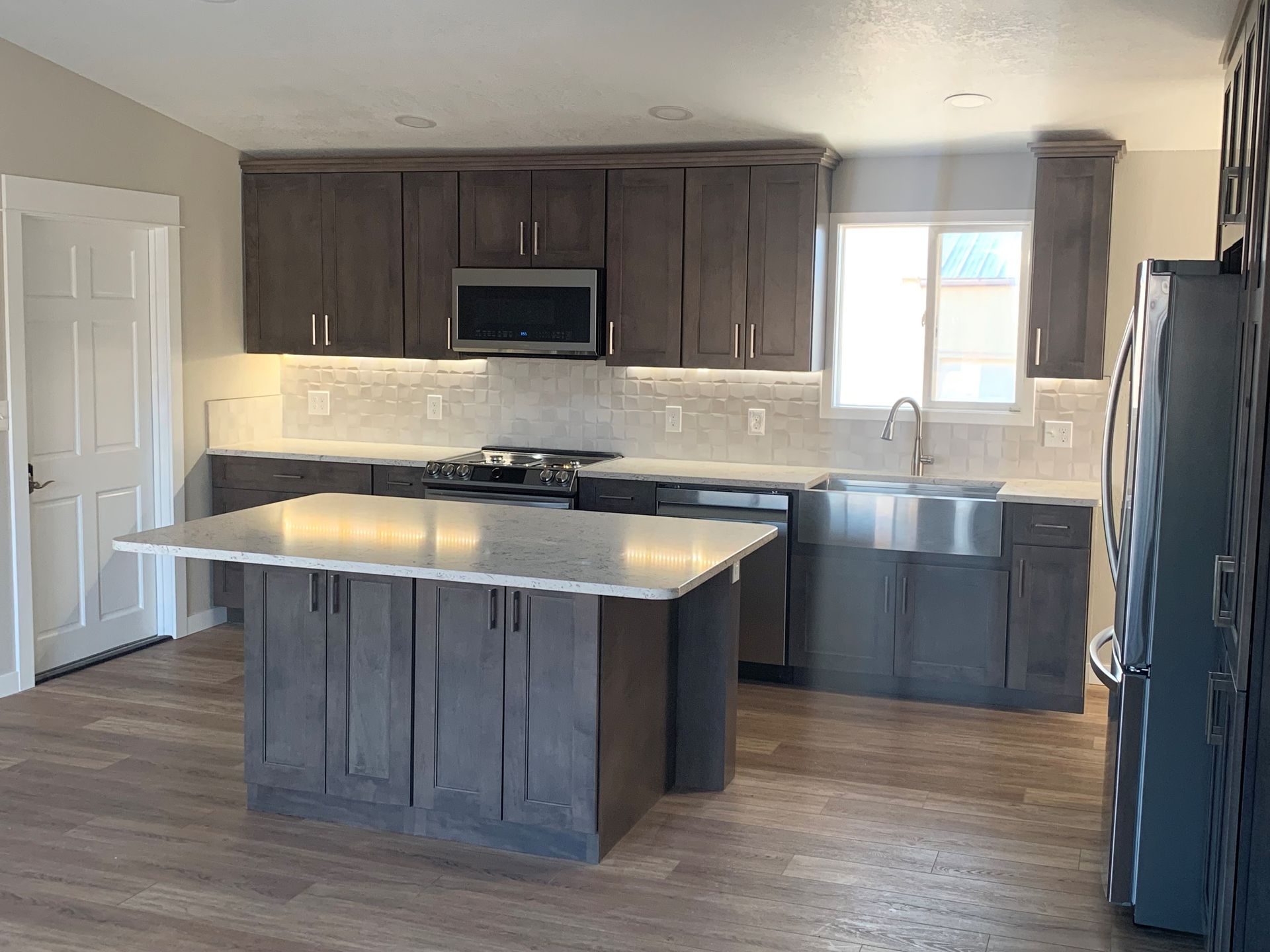 There is a large island in the middle of the kitchen.