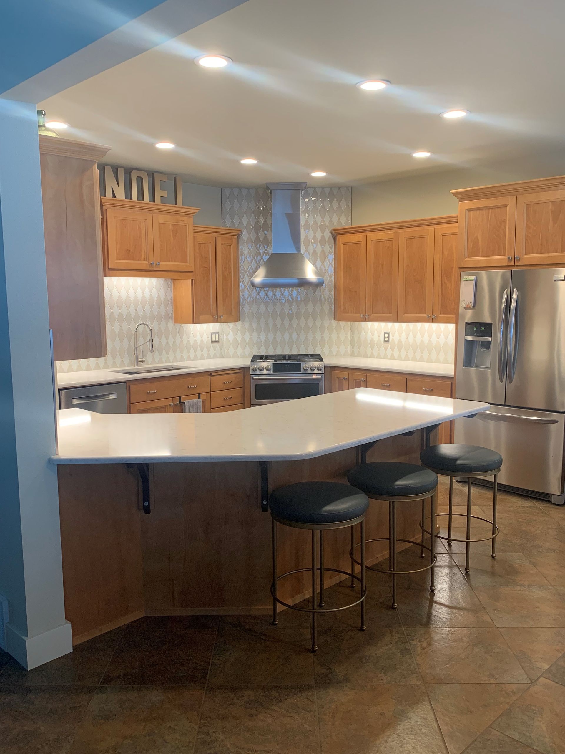 A kitchen with wooden cabinets and stainless steel appliances
