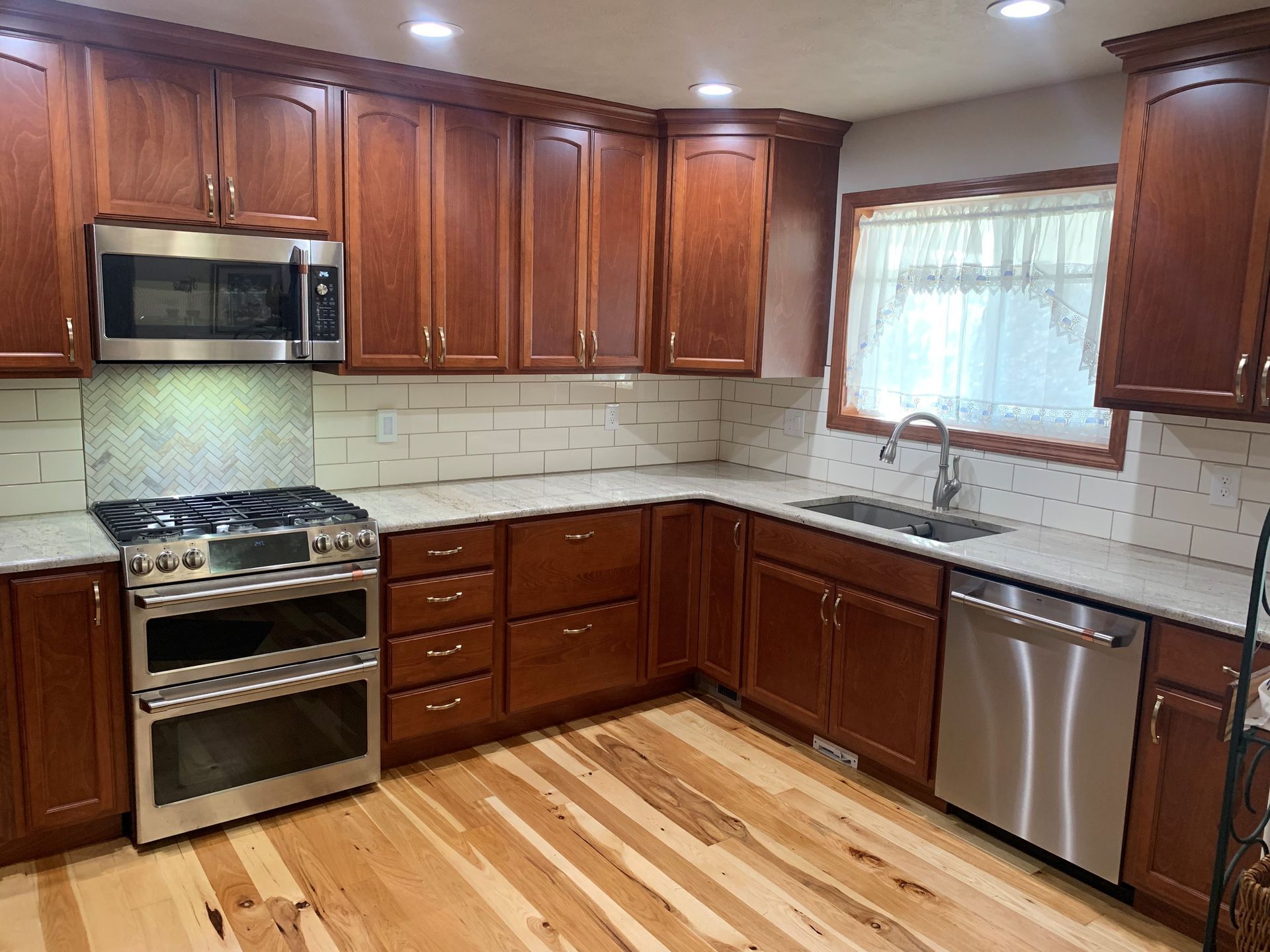 A kitchen with wooden cabinets and stainless steel appliances.