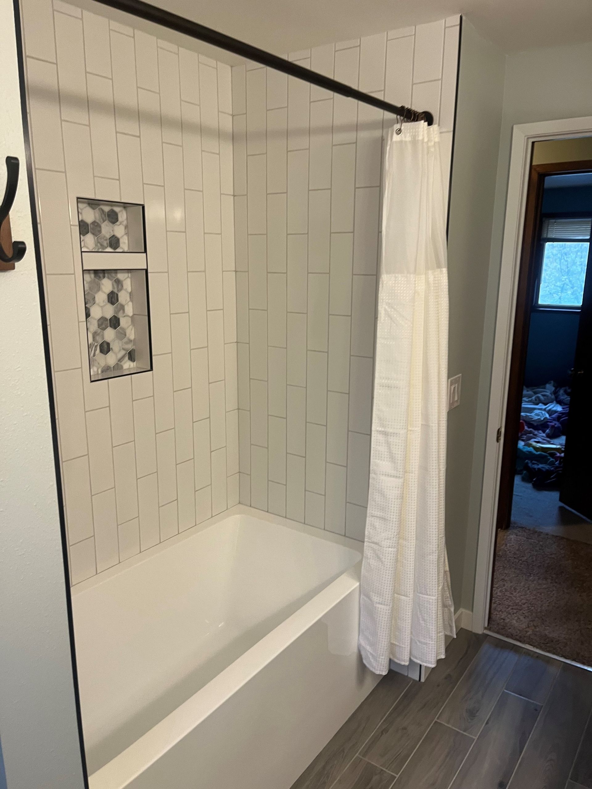 A bathroom with a bathtub and a shower curtain.