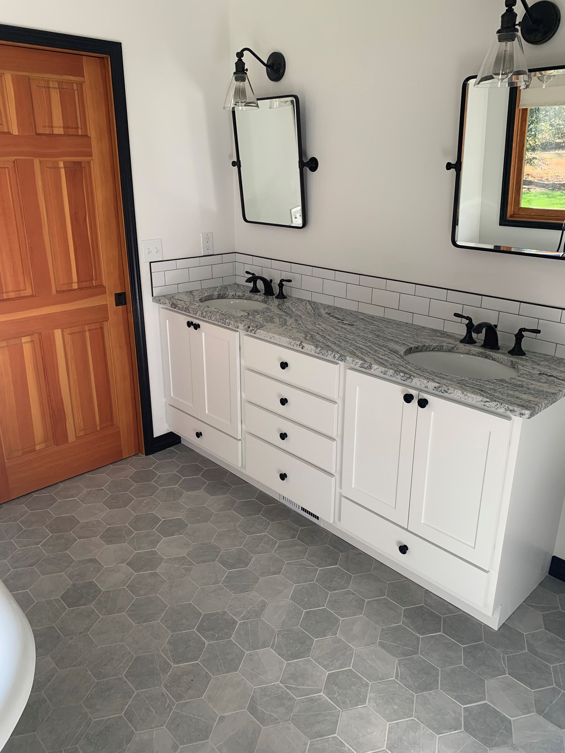 A bathroom with two sinks and two mirrors