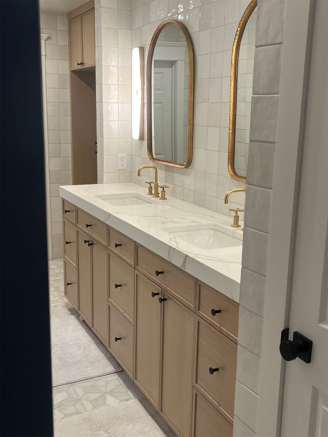 A bathroom with two sinks and two mirrors.