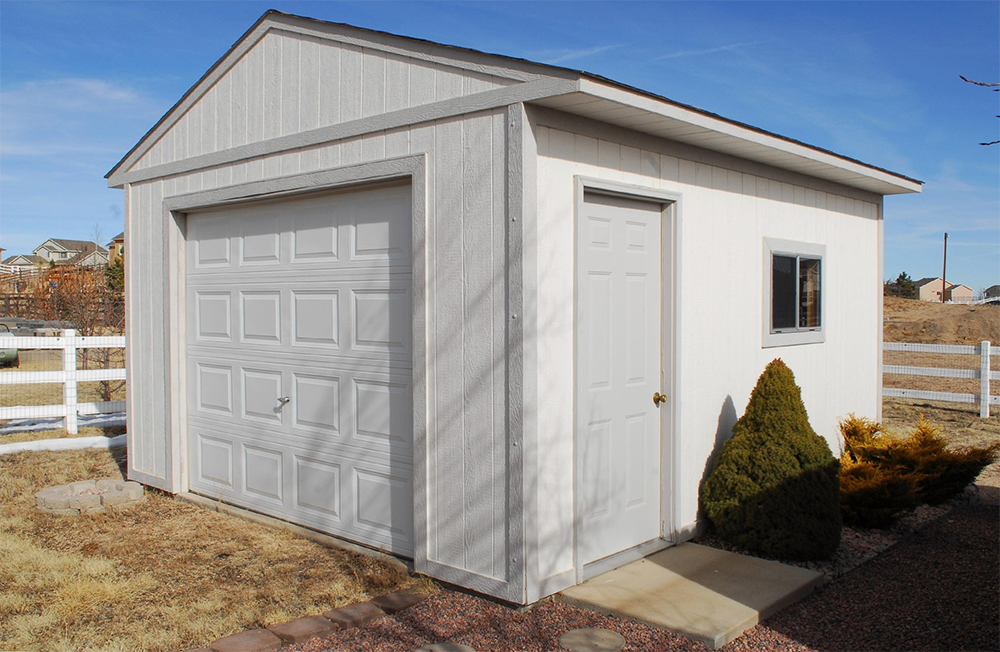 A white garage with a garage door and a window