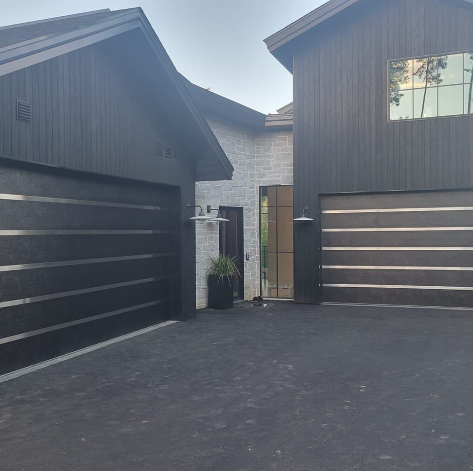 A large house with two black garage doors