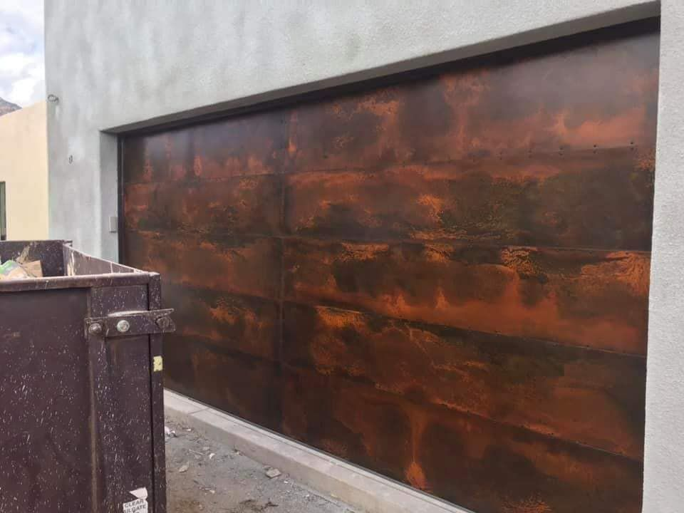 A brown garage door is sitting on the side of a building.