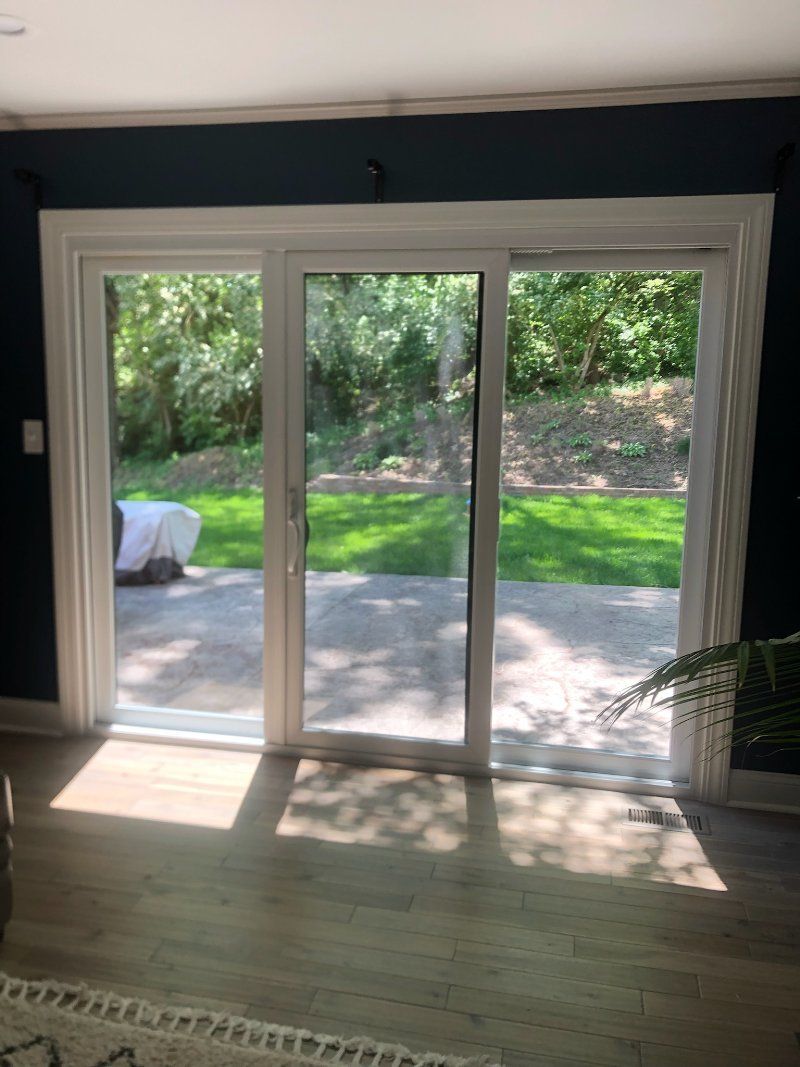 A living room with a sliding glass door leading to a patio.