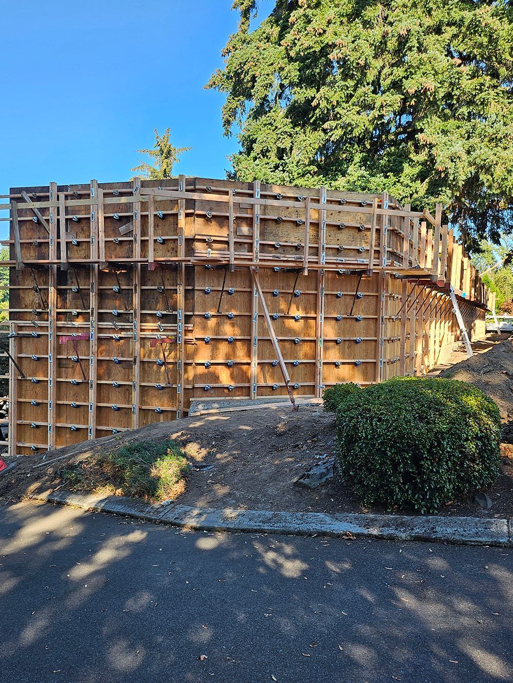 Wooden formwork for a retaining wall under construction.