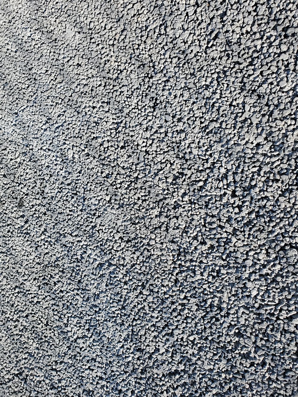 Close-up view of a surface covered in small, gray gravel stones.