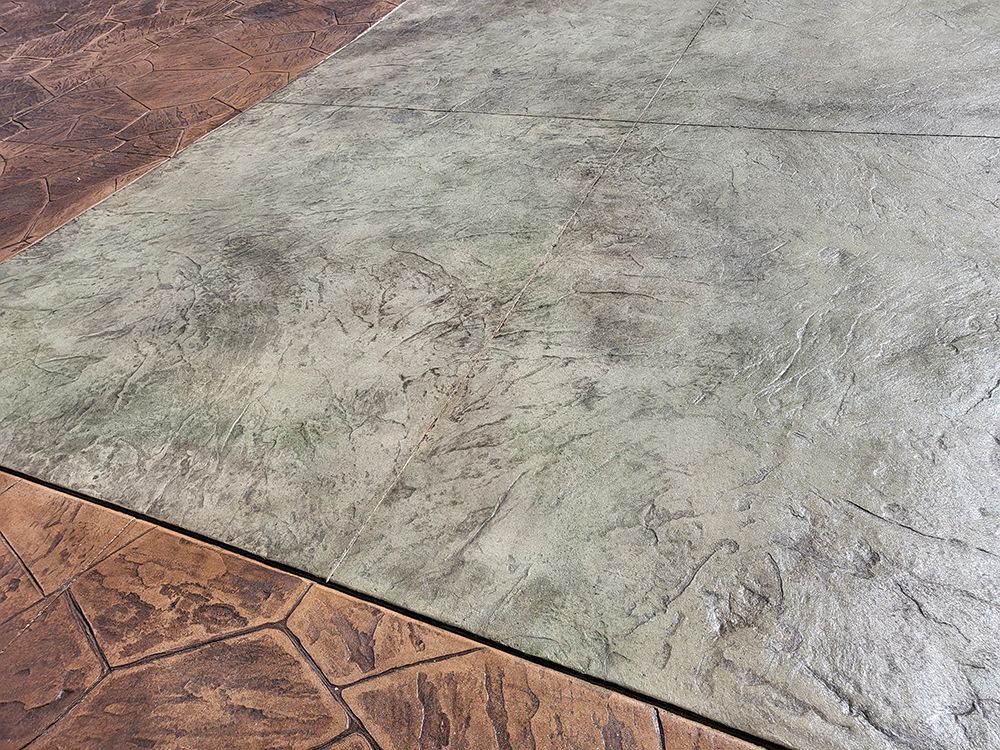 Stamped concrete patio with brown and green sections.