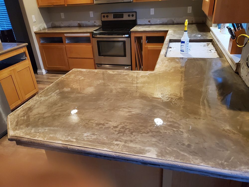 Kitchen with brown countertops, cabinets, and appliances. Empty cabinet spaces are visible.