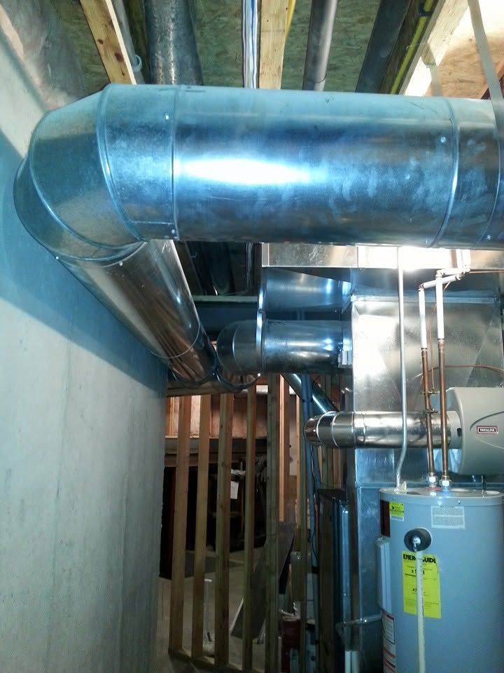 Metal HVAC ducts and equipment in a basement utility room