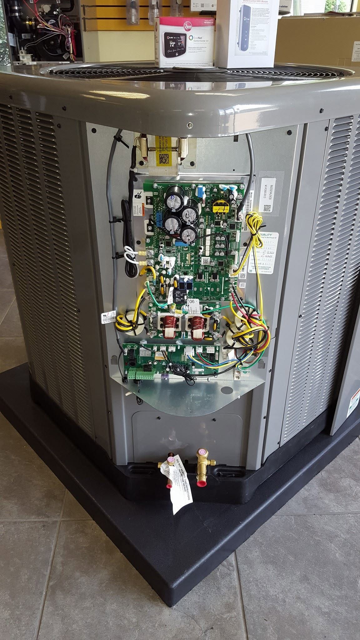 Industrial machine cabinet with an open front panel exposing circuit boards and wiring.