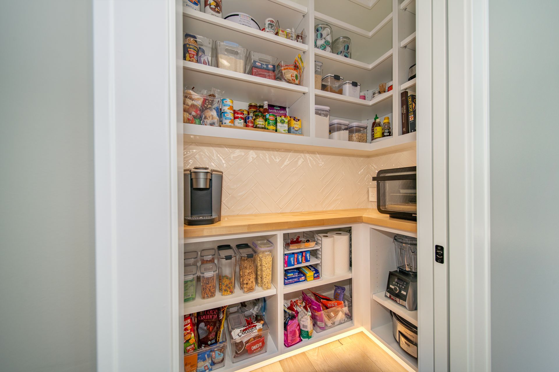 A pantry filled with lots of food and appliances.