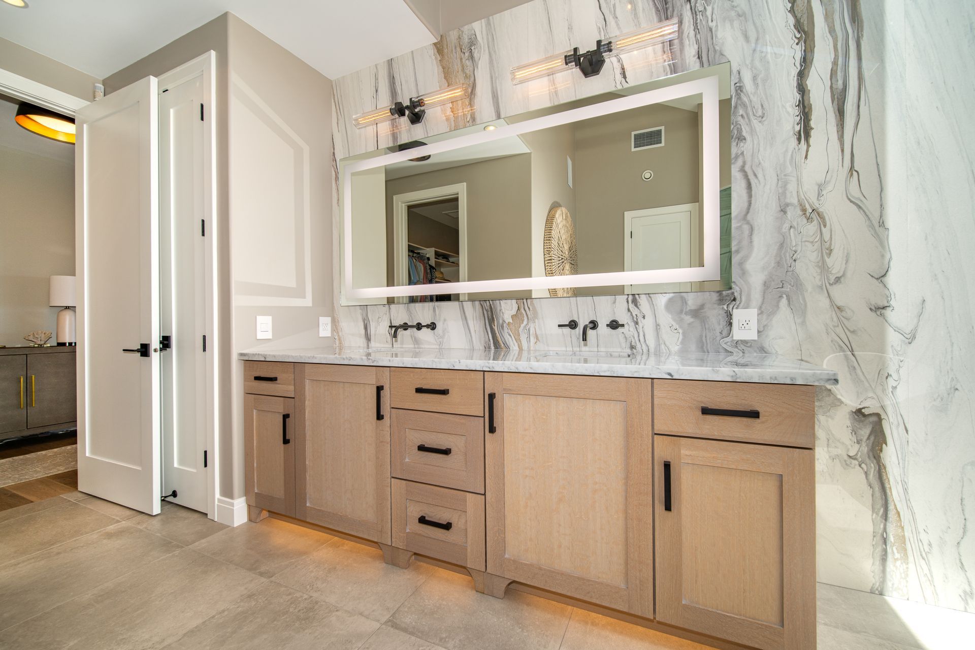 A bathroom with two sinks and a large mirror.