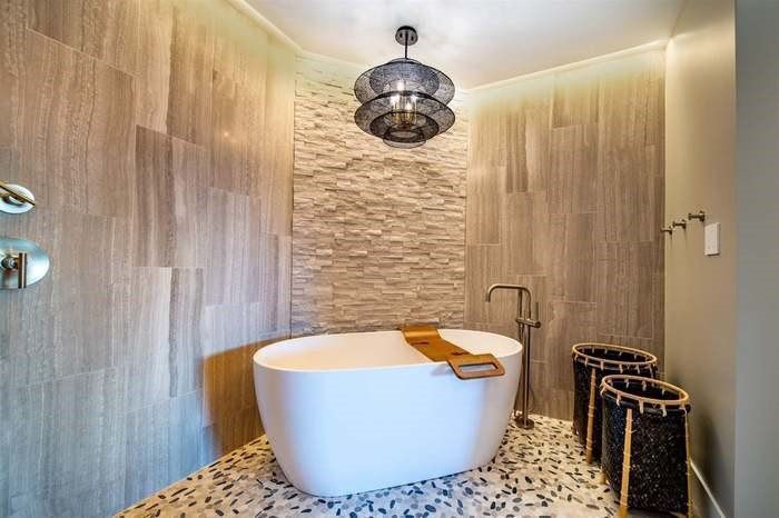 There is a bathtub in the middle of the bathroom.