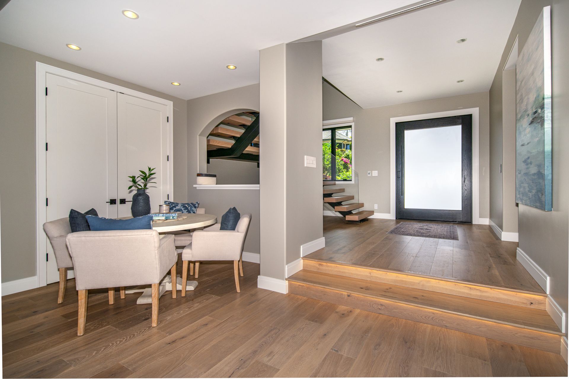 There is a table and chairs in the middle of the room.