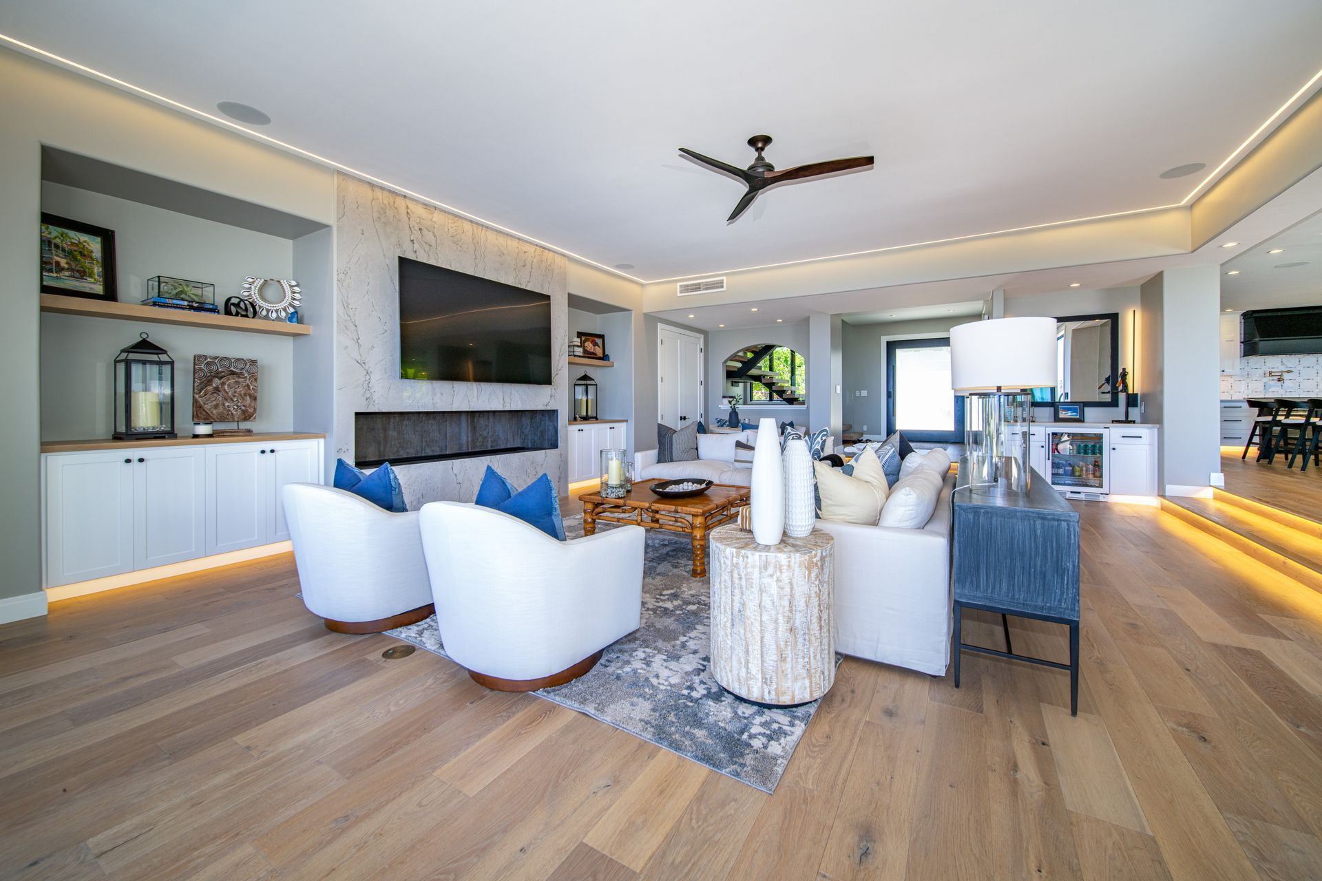 A living room filled with furniture and a ceiling fan.