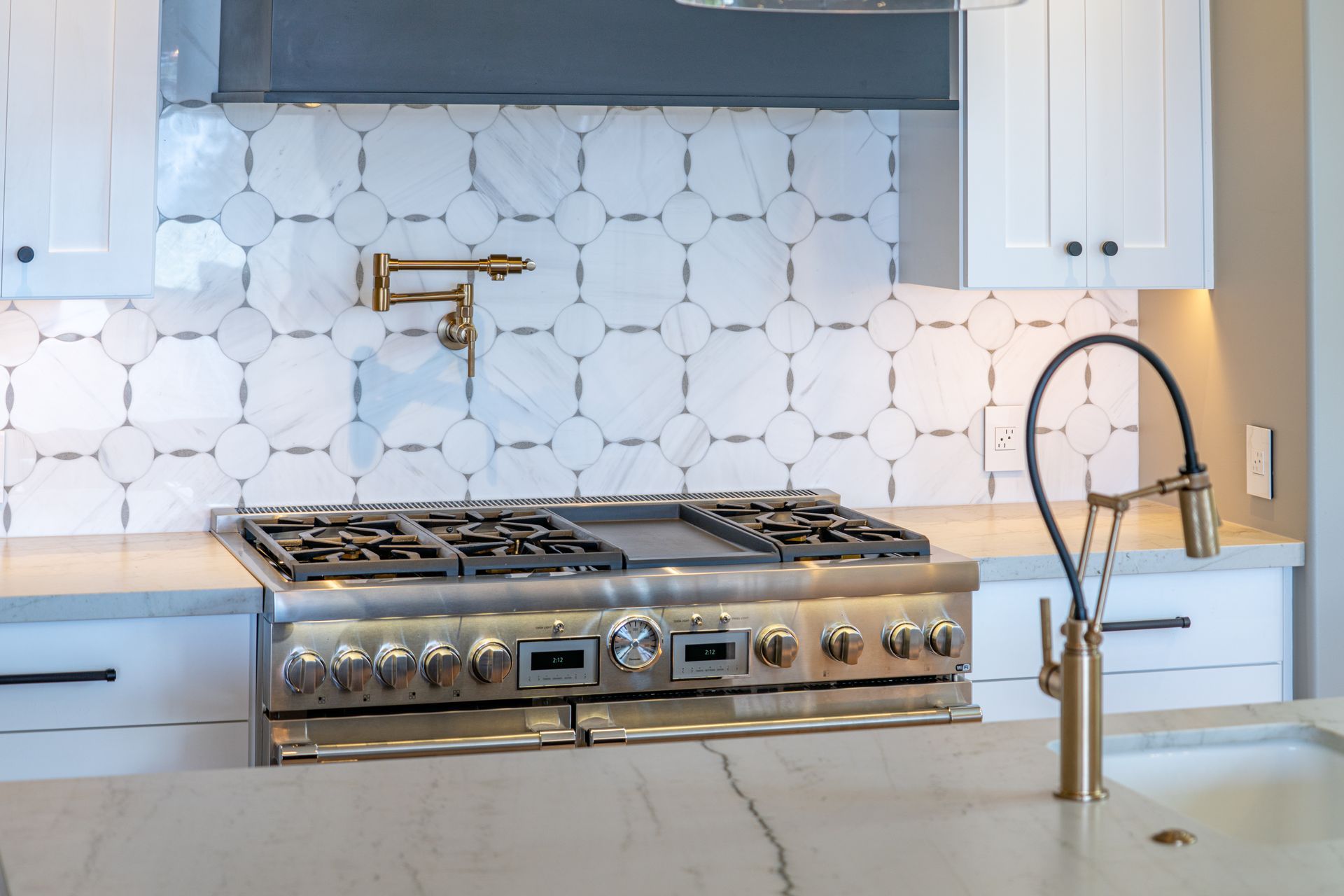 A kitchen with a stove top oven and a sink.