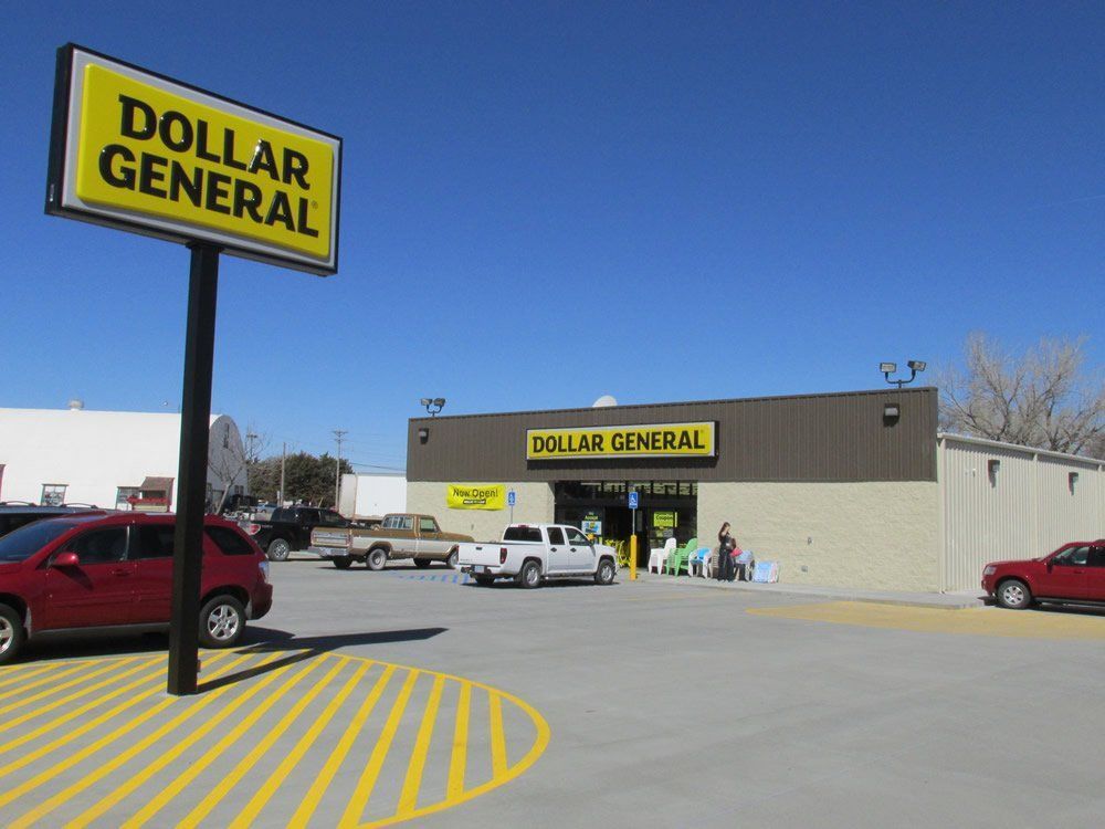 A dollar general store with cars parked in front of it
