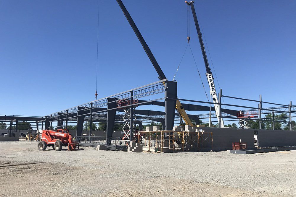 A construction site with a lot of machinery and cranes.