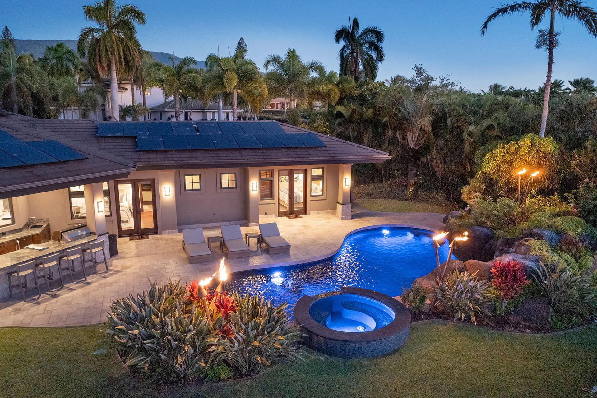 An aerial view of a beach with a golf course and mountains in the background