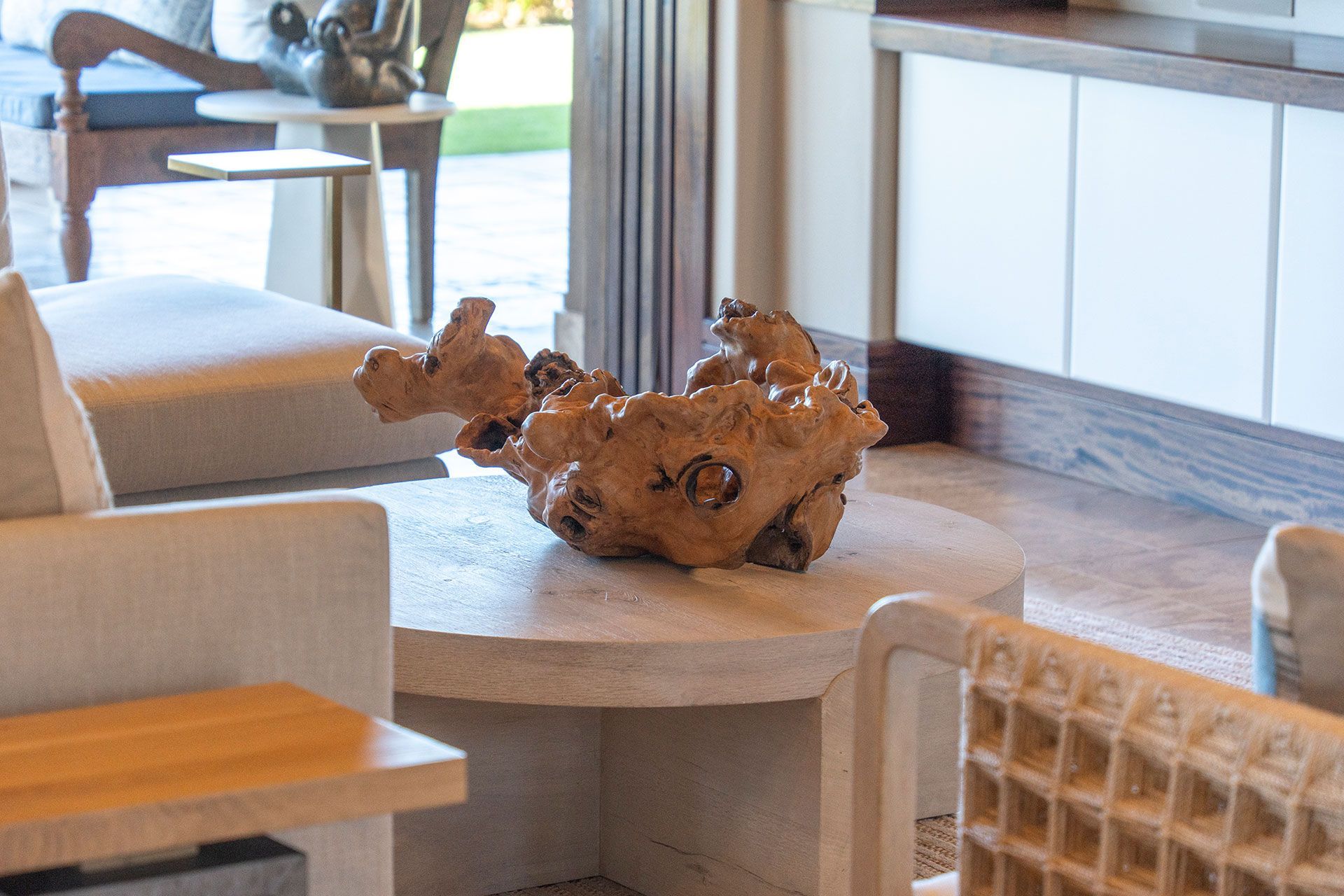 A living room with a wooden sculpture on a table