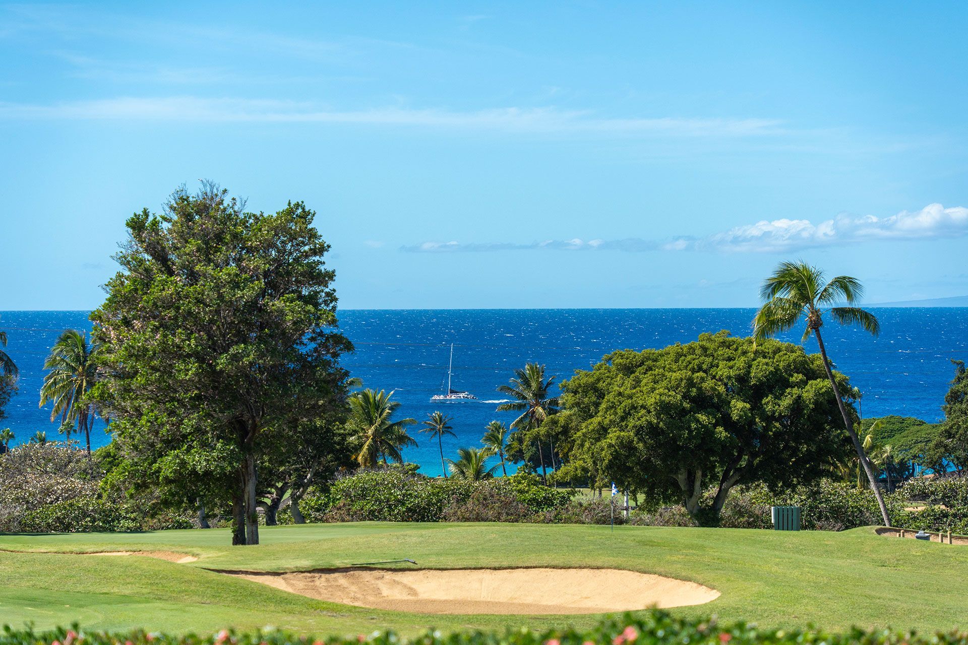 There is a golf course with a view of the ocean.