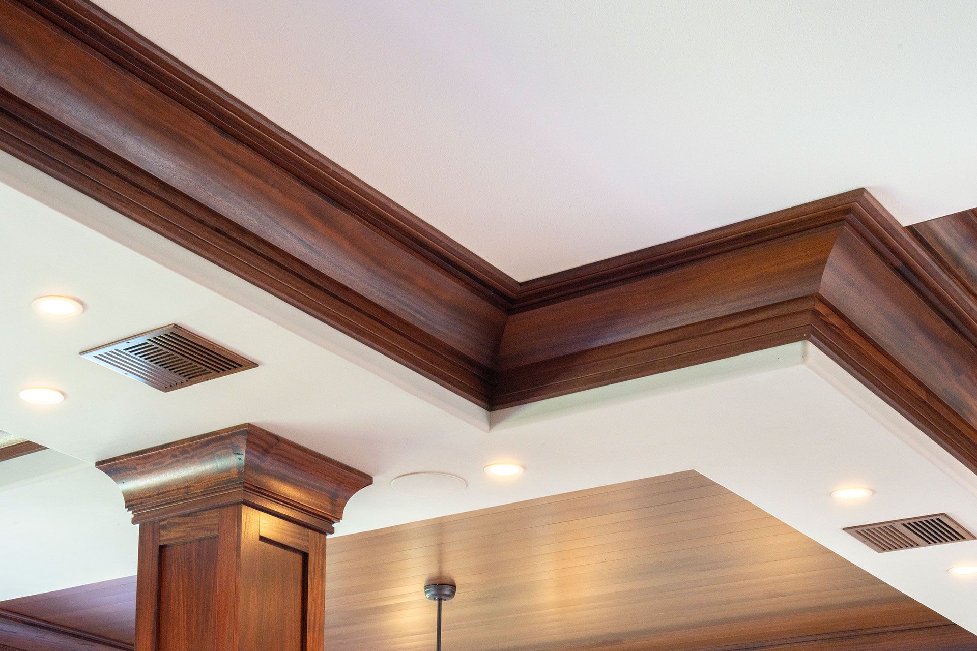 A ceiling with a wooden trim and a white ceiling