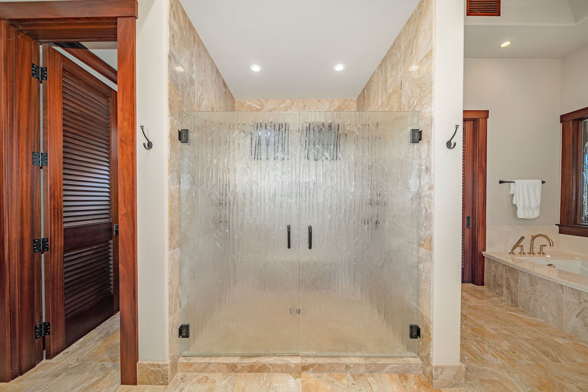 A bathroom with a walk in shower and a bathtub