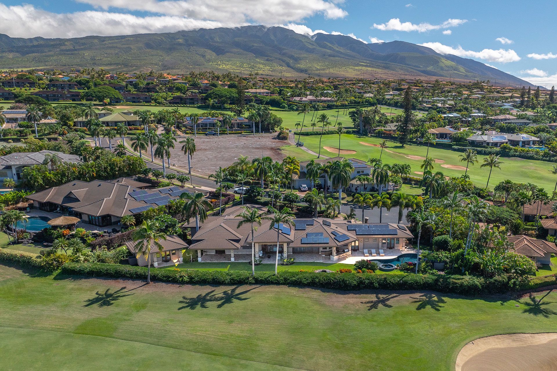 An aerial view of a residential area with mountains in the background