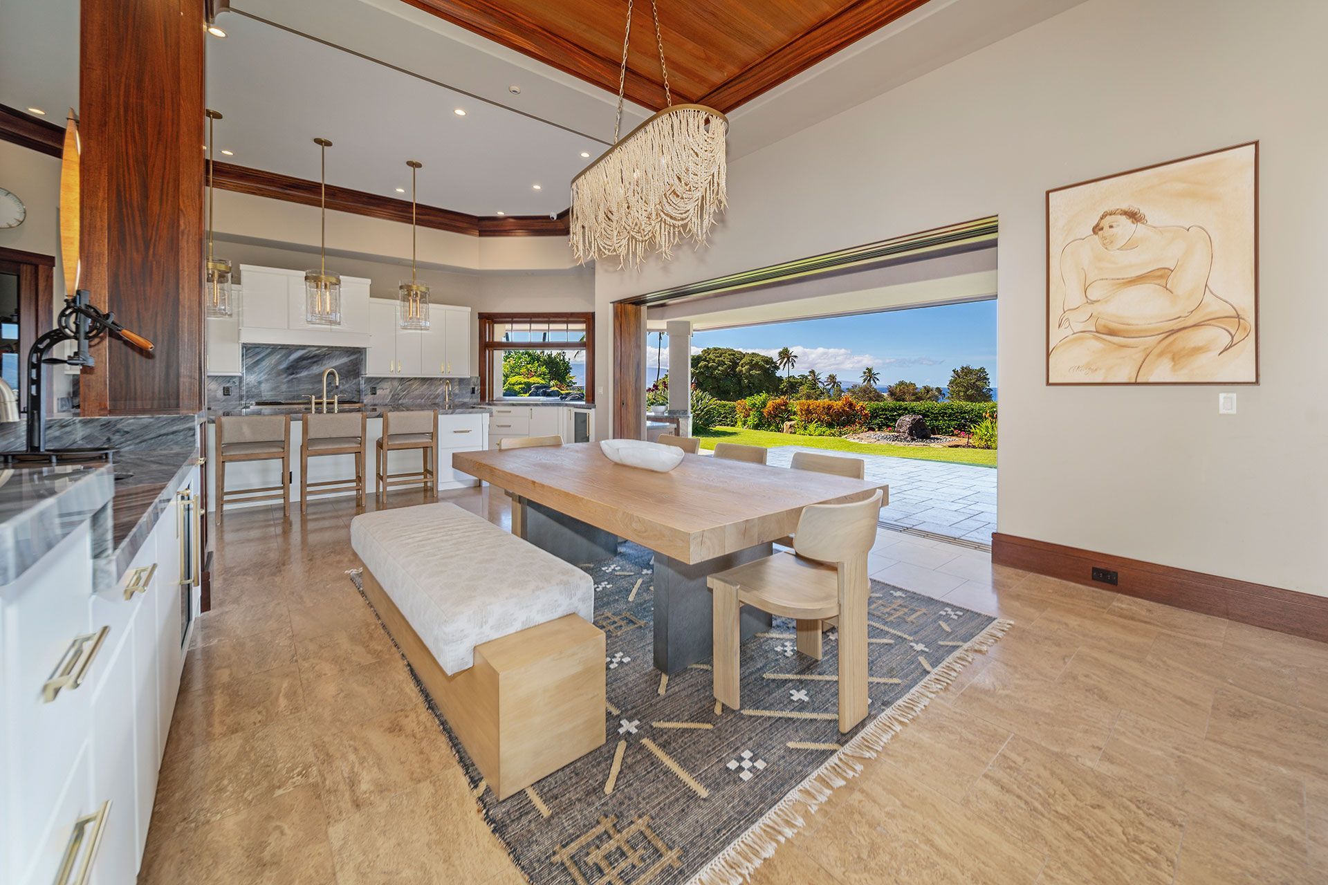 A dining room with a table and chairs and a bench