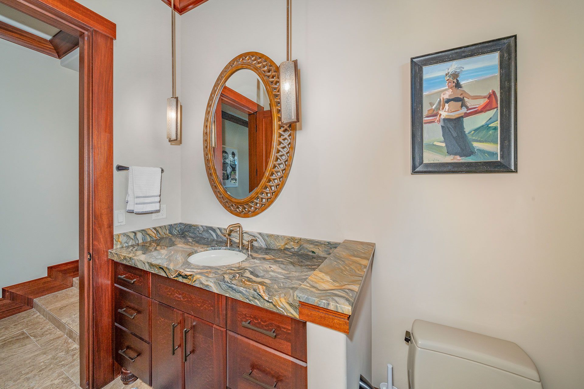 A bathroom with a sink, mirror and toilet